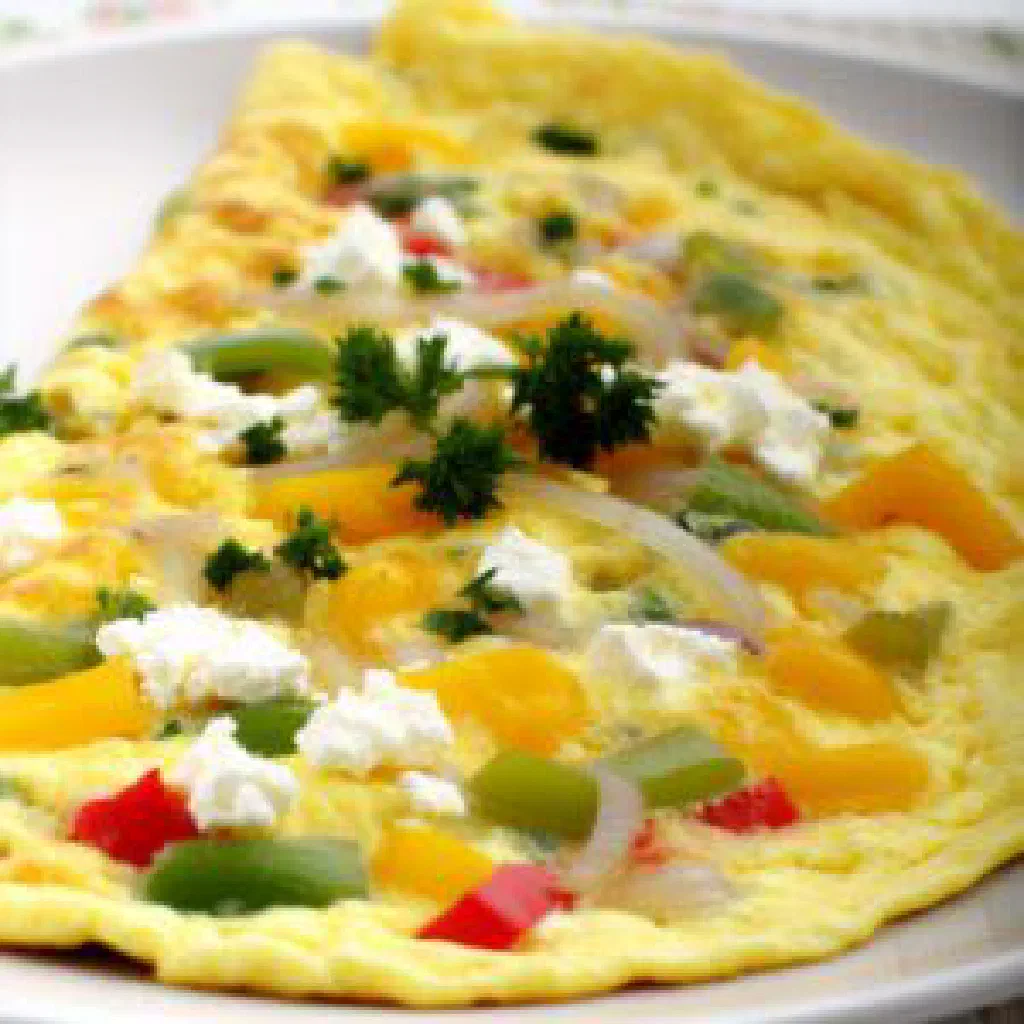 Albanian breakfast pan with scrambled eggs, feta, tomatoes and peppers