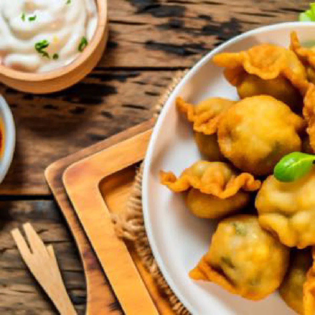 Golden fried Creponne pastries garnished with fresh parsley