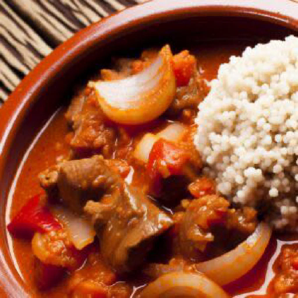Bowl of Dchicha, fine semolina with a rich meat sauce and fresh herbs