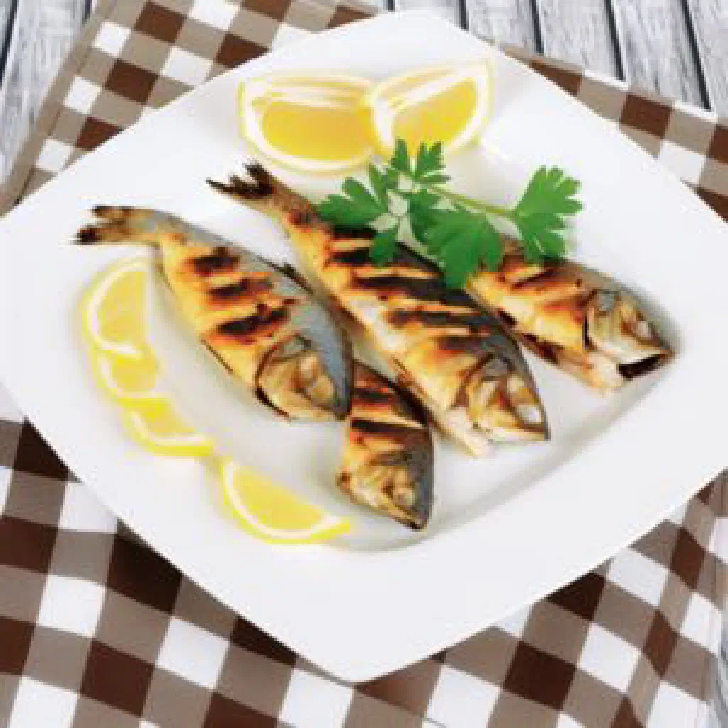Grilled Armenian ishkhan trout with fresh herbs and lemon slices