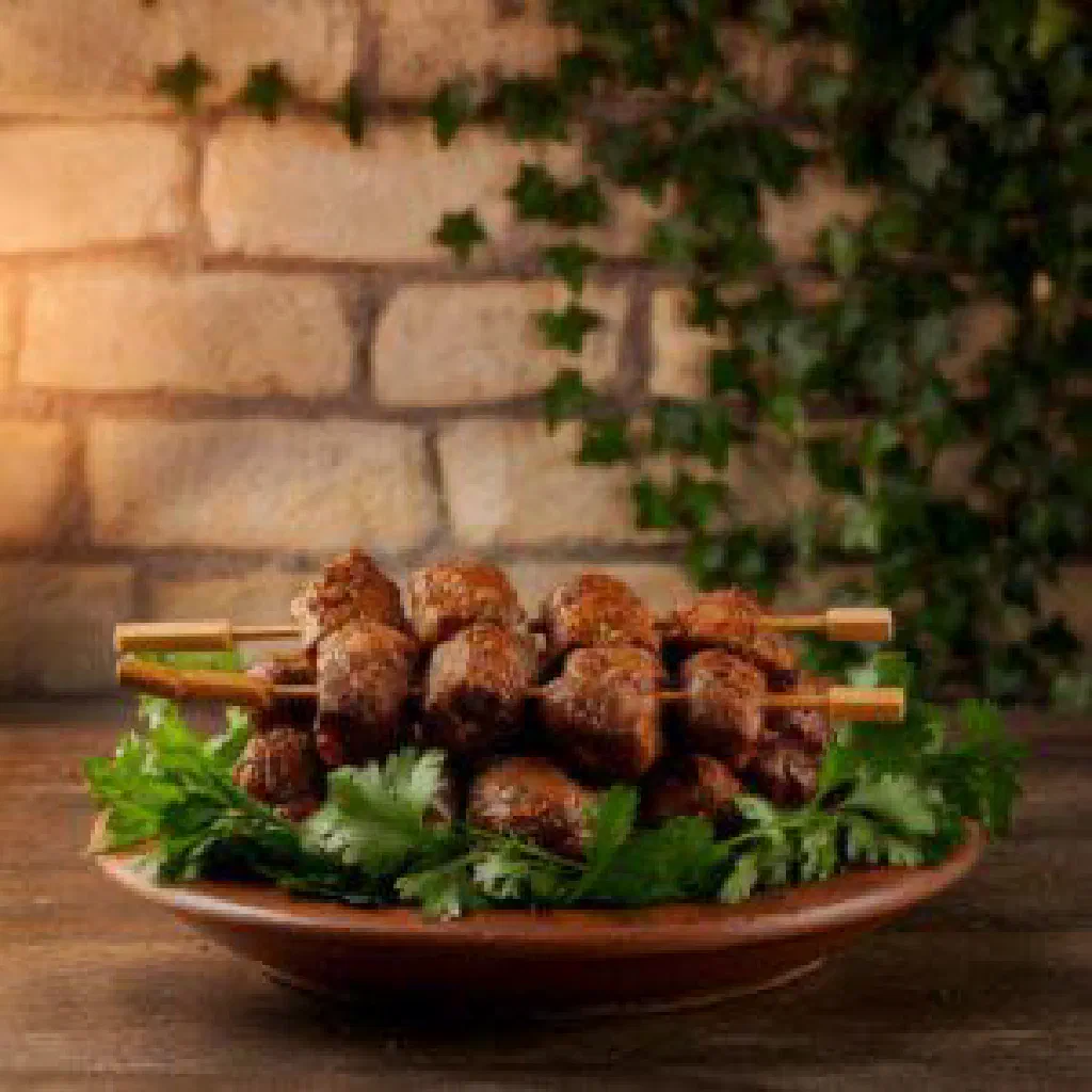 Grilled khorovats meat skewers with charred peppers and tomatoes