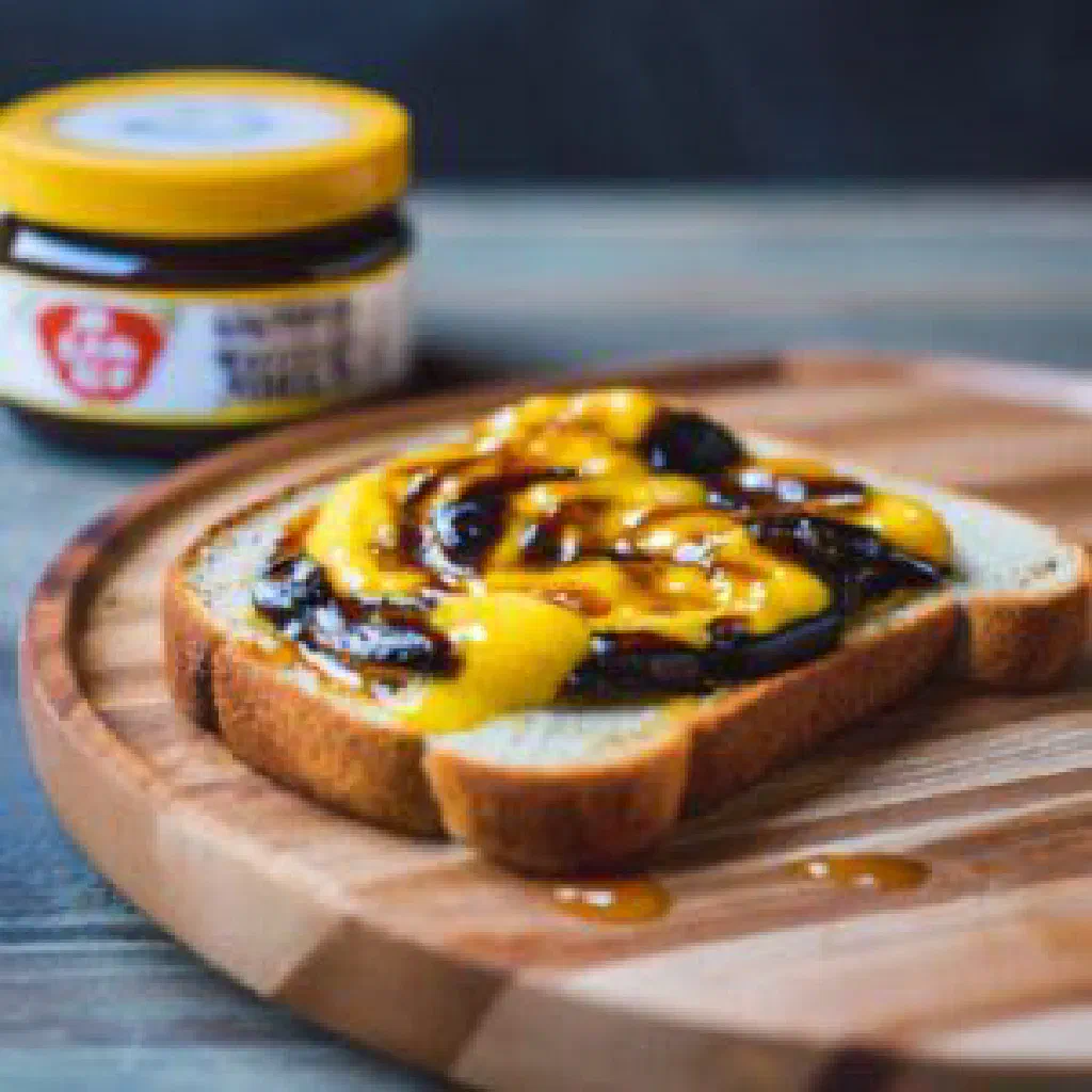 Slice of toast spread with dark Vegemite and butter