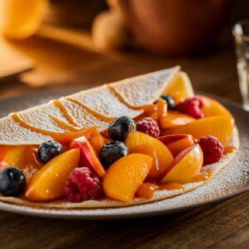 Rolled Austrian fruit pancakes dusted with icing sugar and cinnamon