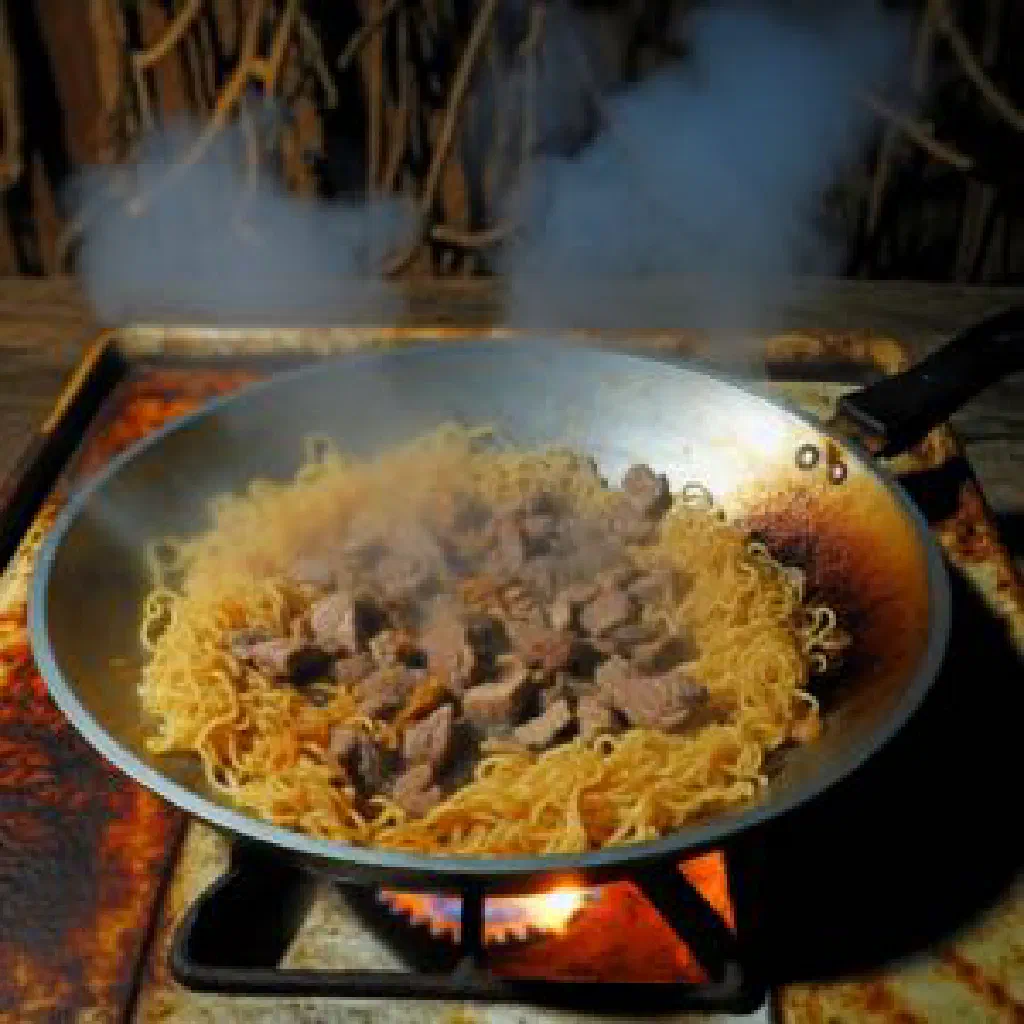 Bowl of sulu khingal with hand-cut noodles, lamb and broth, topped with fresh herbs