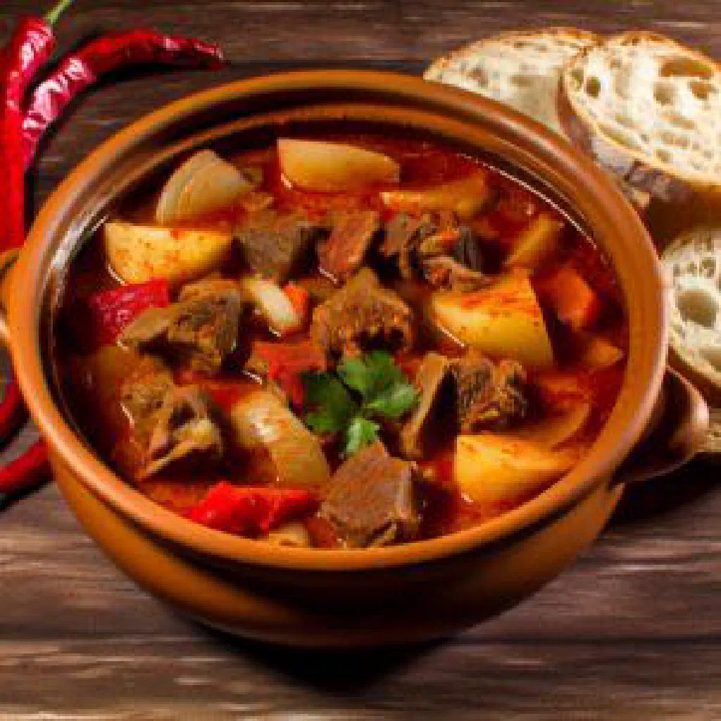 Azerbaijani tava with braised meat, peppers and tomatoes in an earthenware pot