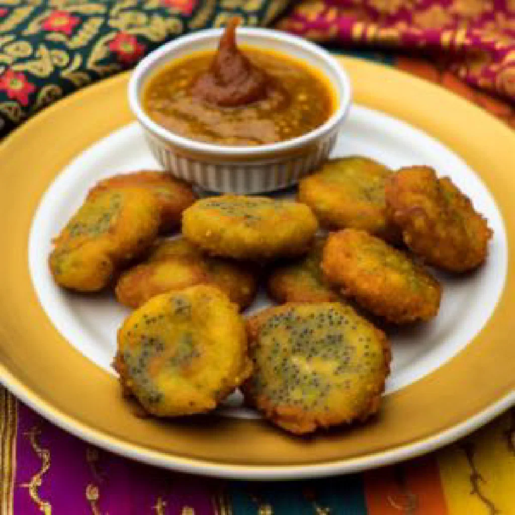 Golden-fried poppy seed fritters garnished with fresh coriander