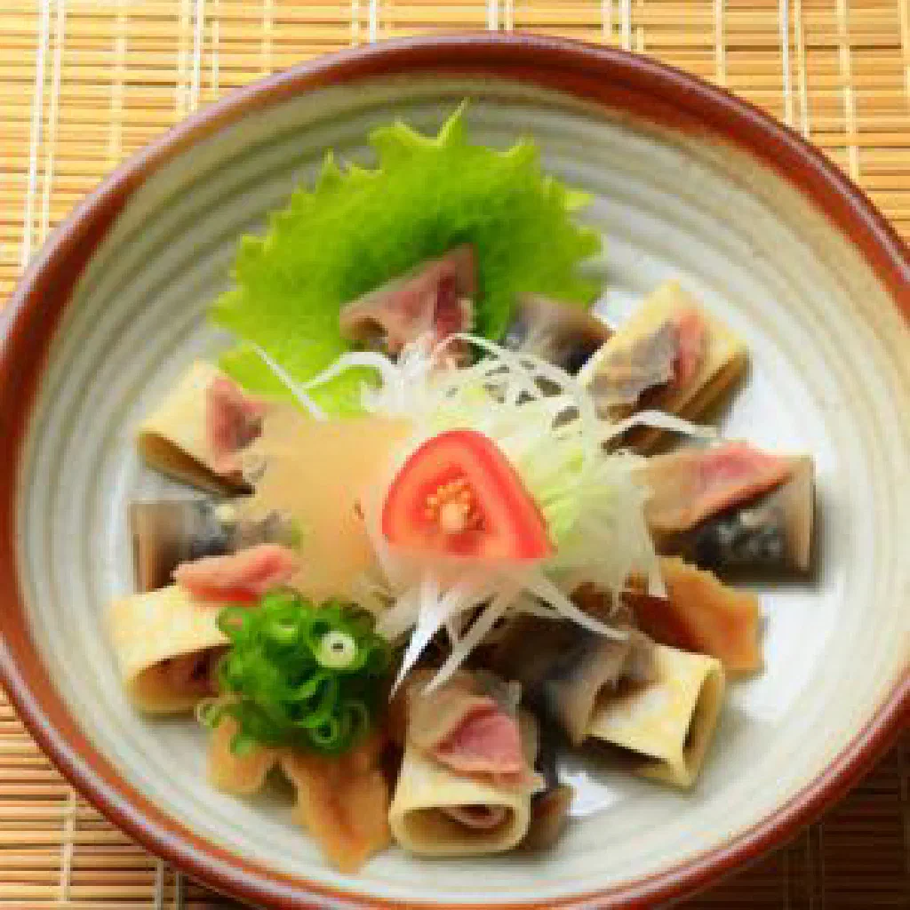 Small glasses of clear Bulgarian rakiya beside fresh plums