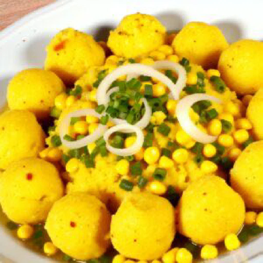 Smooth mounds of tô made from maize flour, served with a vegetable sauce