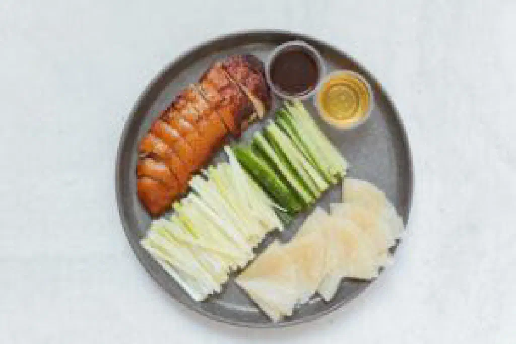 Crispy Peking duck with spring onions and a glossy sweet-and-sour sauce