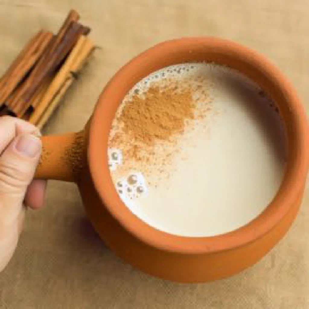 Warm creamy corn drink in a cup dusted with cinnamon