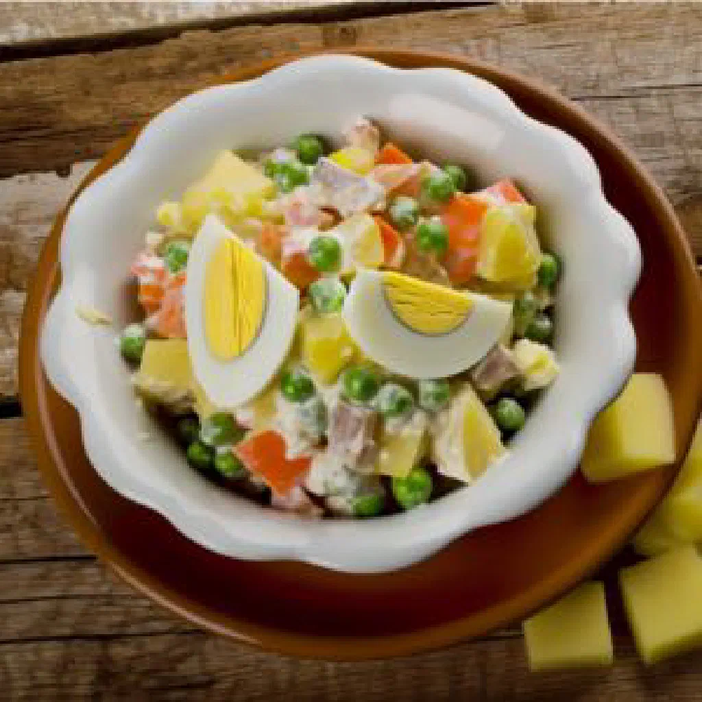 Colourful Costa Rican Russian salad with diced potatoes, carrots, peas and egg in mayonnaise