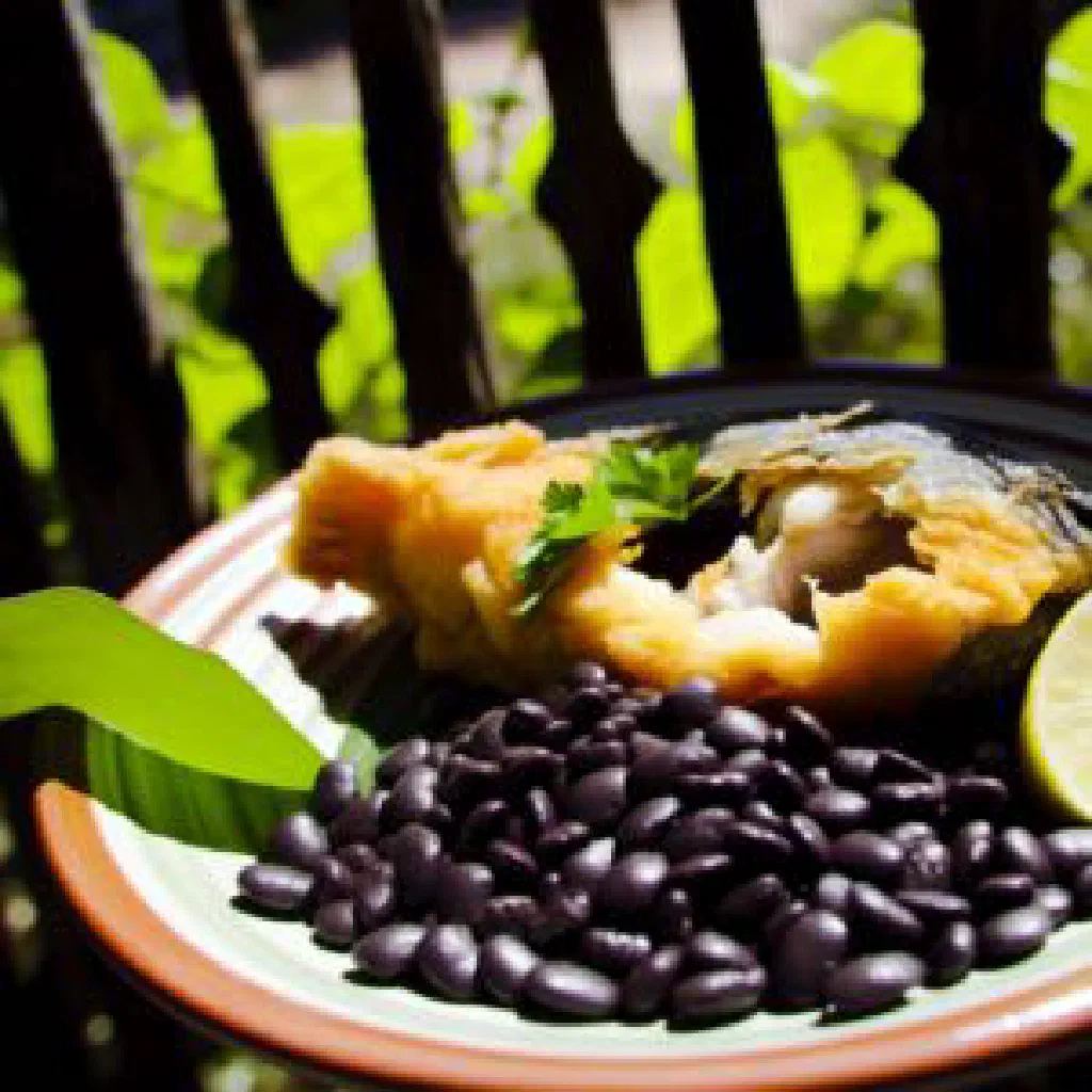 Whole fried fish served with rice, black beans and lime