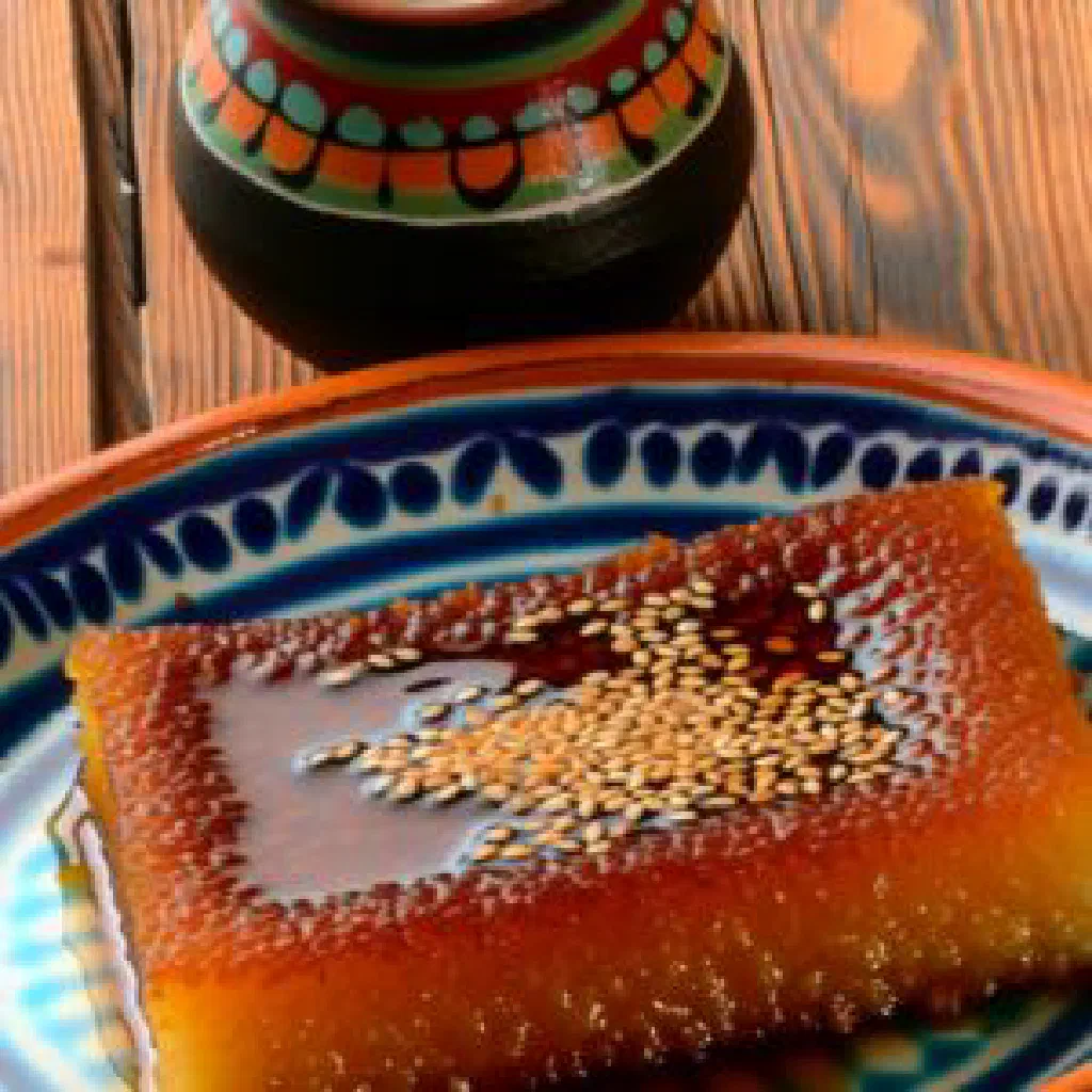 Slices of golden semolina Revani cake soaked in lemon syrup and topped with almonds