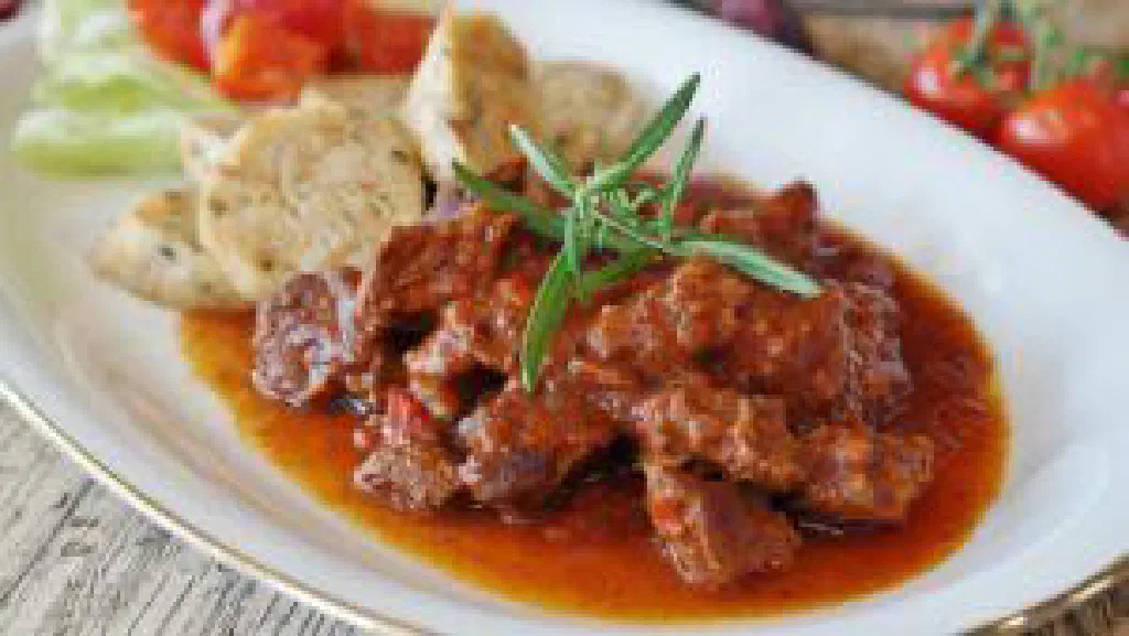Czech dumplings with roast pork in a rich paprika goulash sauce