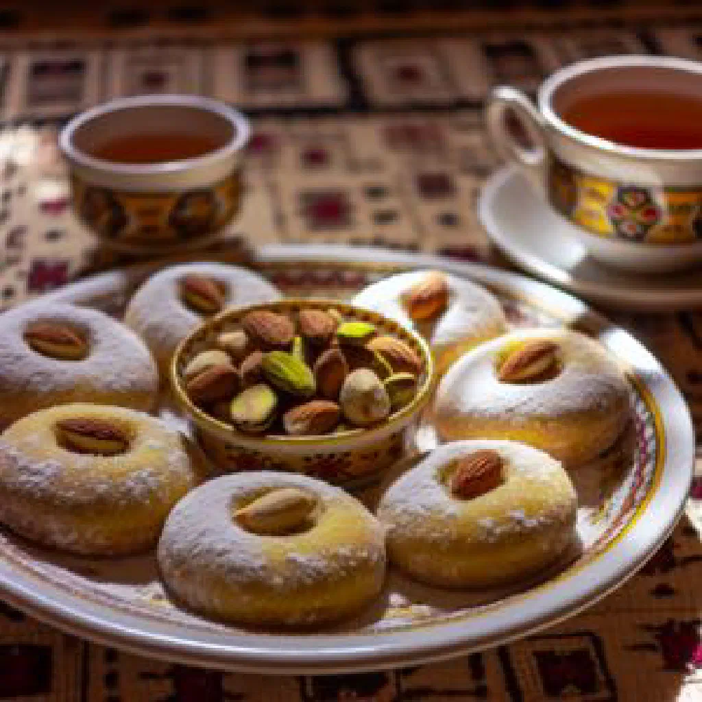 Round Egyptian kahk cookies dusted with powdered sugar