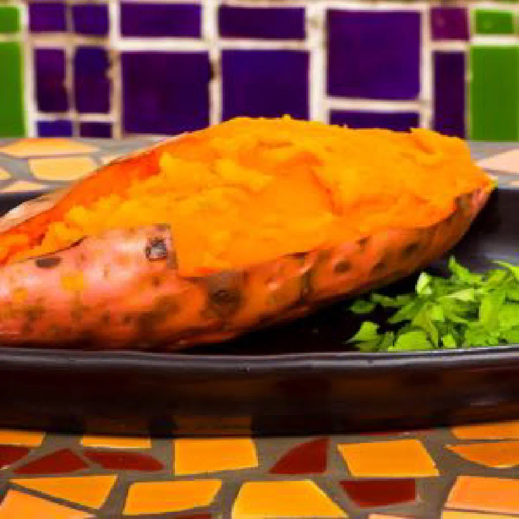 Roasted sweet potato cubes garnished with fresh herbs