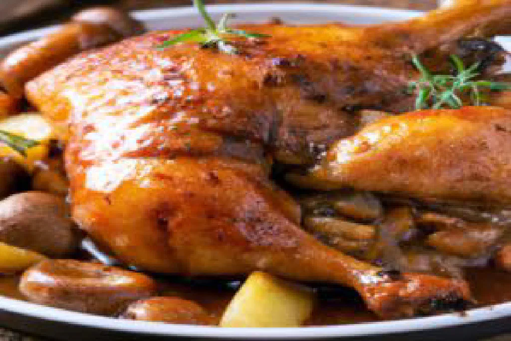 Coq au vin with chicken braised in red wine sauce with mushrooms and bacon