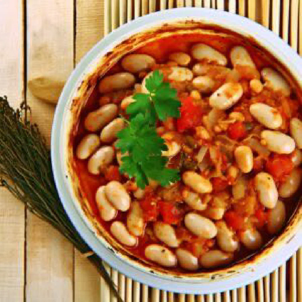 Gigantes plaki, giant baked beans in tomato sauce garnished with parsley