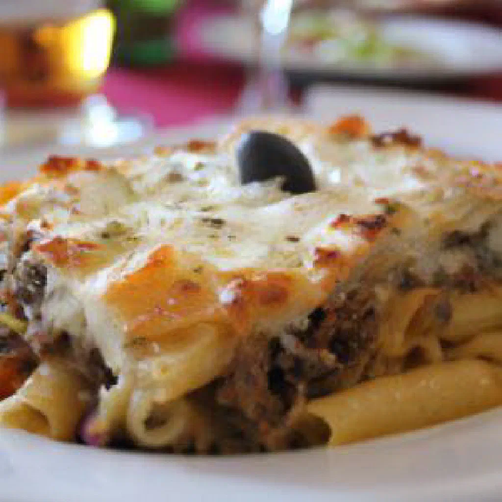 Golden-baked pastitsio with layers of macaroni, minced meat and béchamel