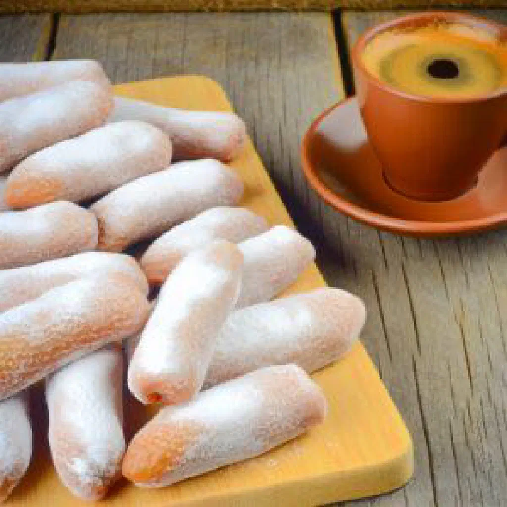 Sliced soutzouk loukou dusted with icing sugar showing the nuts inside