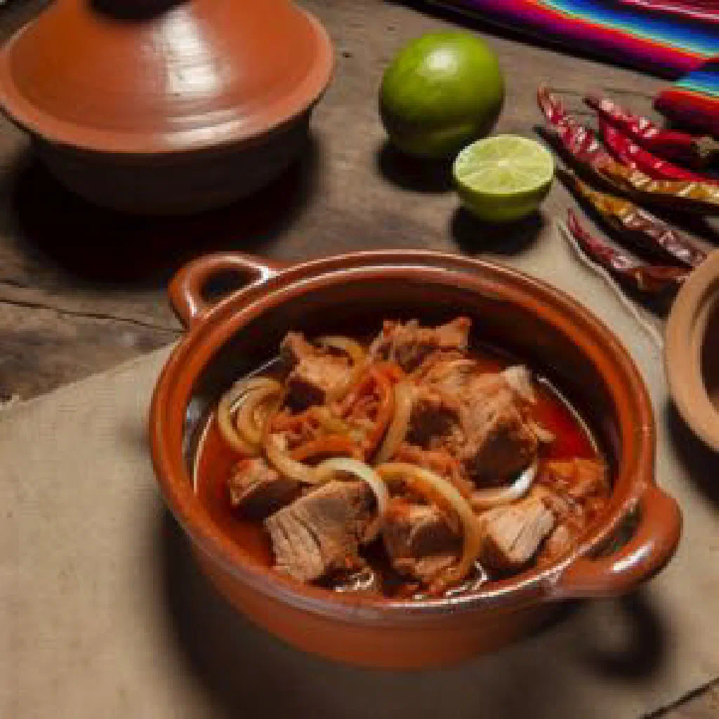 Guatemalan revolcado de cerdo with pork simmered in a spiced tomato sauce