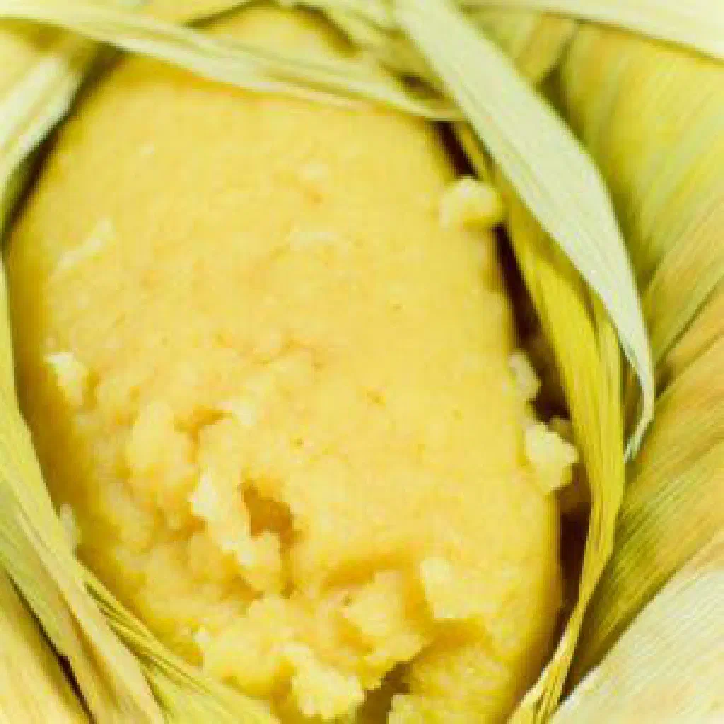 Golden sweet corn tamalitos de elote on a plate