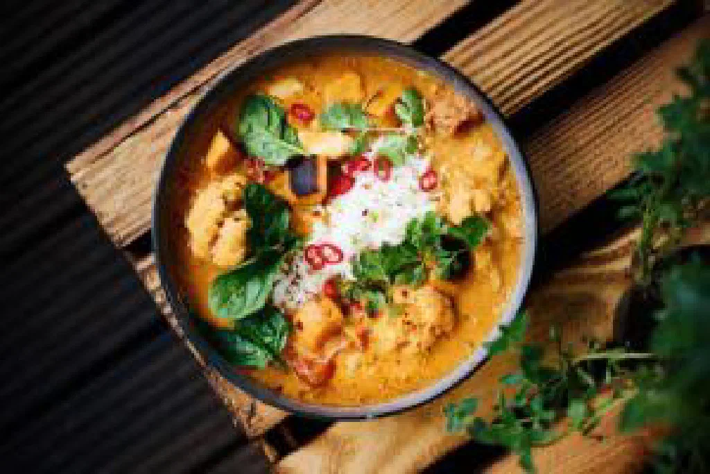 A bowl of fragrant Indian curry topped with fresh coriander