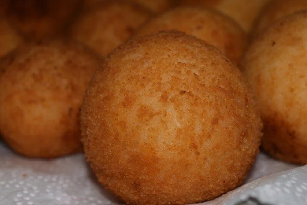 Golden, crisp fried arancini rice balls with a molten cheese centre