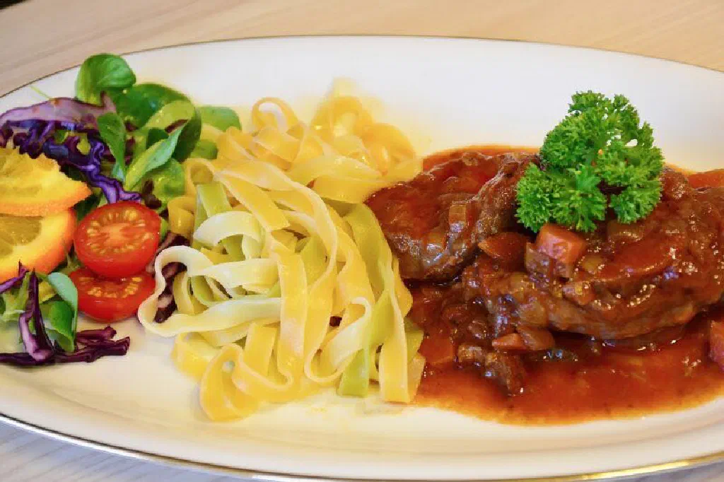 Braised ossobuco in a rich sauce topped with fresh gremolata