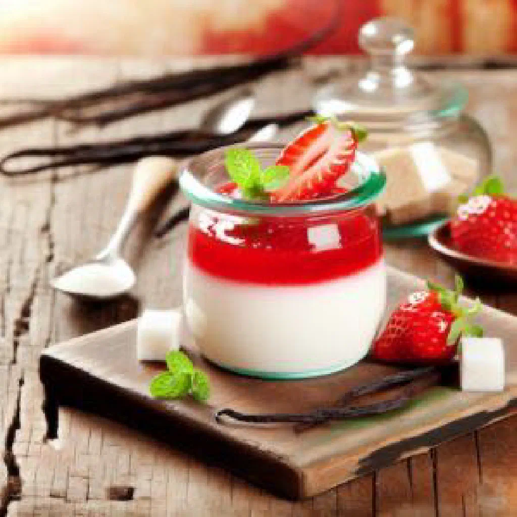 Creamy panna cotta turned out onto a plate with fresh berries