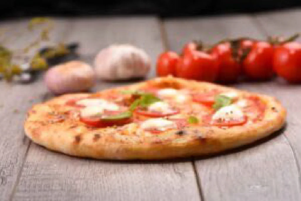 Freshly baked pizza Margherita topped with tomato, mozzarella and basil