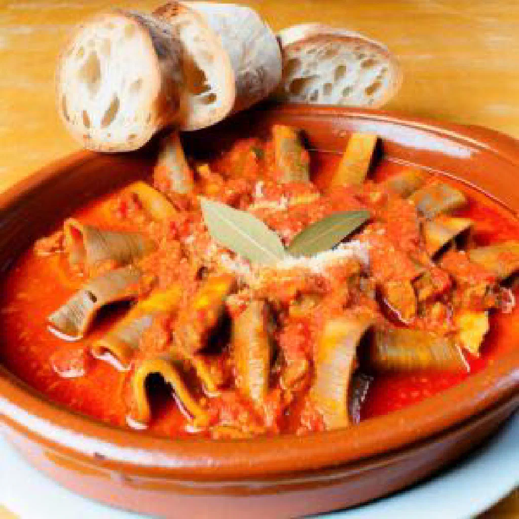 Trippa alla Romana in a rich tomato sauce topped with grated pecorino and fresh mint