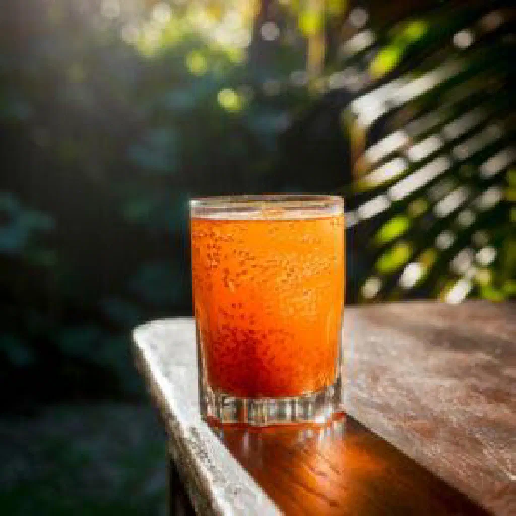 A tall glass of freshly pressed sugar cane juice served over ice