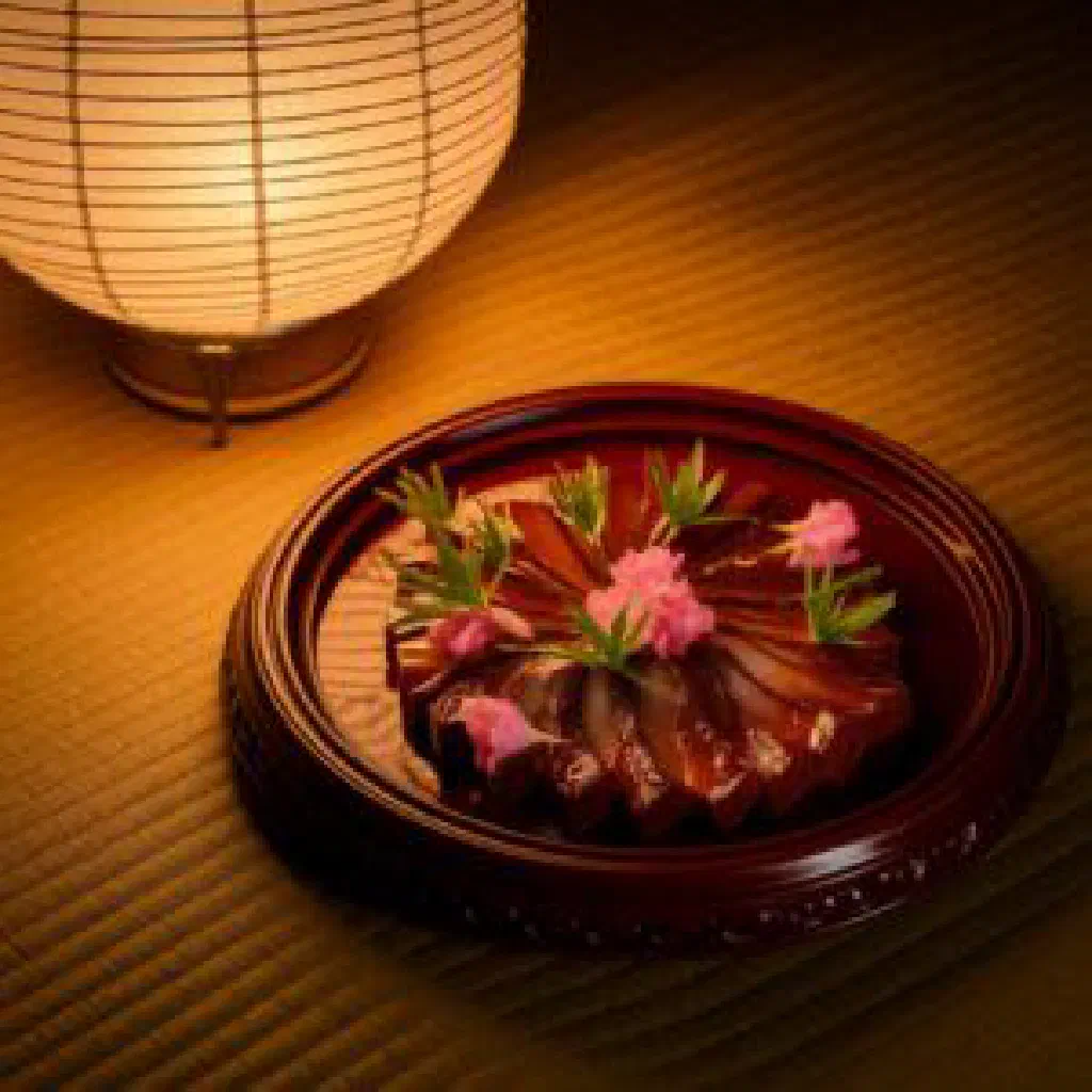 Pan-cooked Japanese venison in a soy and mirin sauce, garnished with fresh herbs