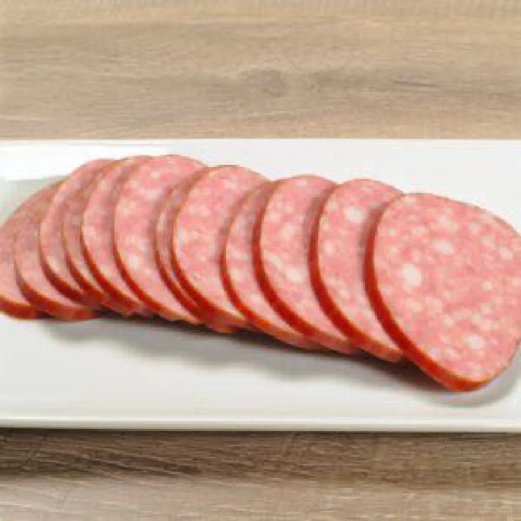 Sliced Kazylyk horse-meat sausage arranged on a wooden board