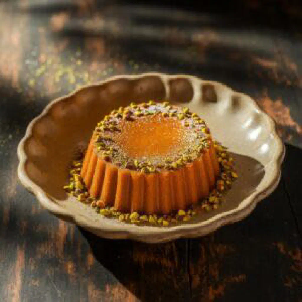 Amber-coloured halwa bahraini squares studded with pistachios