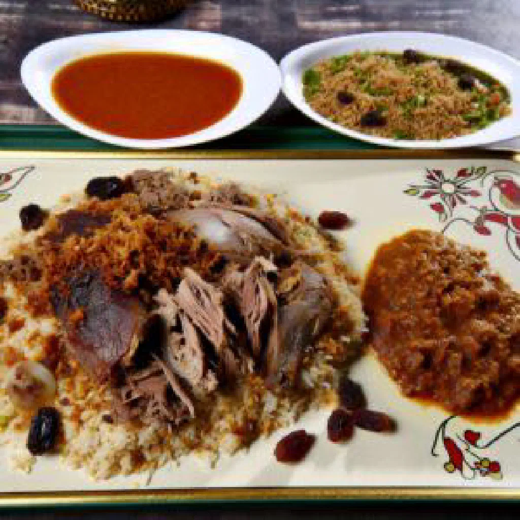 Mandi with spiced rice and tender meat on a large serving platter