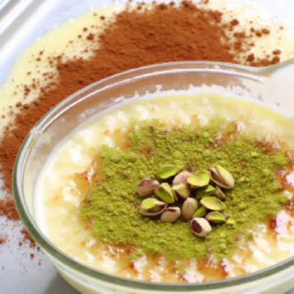Creamy Lebanese rice pudding topped with cinnamon and chopped nuts