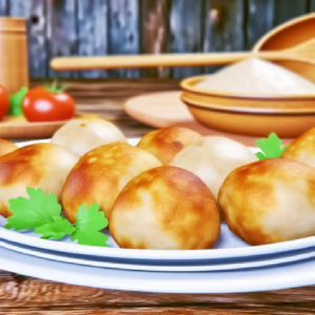 Golden-fried Luxembourgish potato dumplings garnished with fresh herbs
