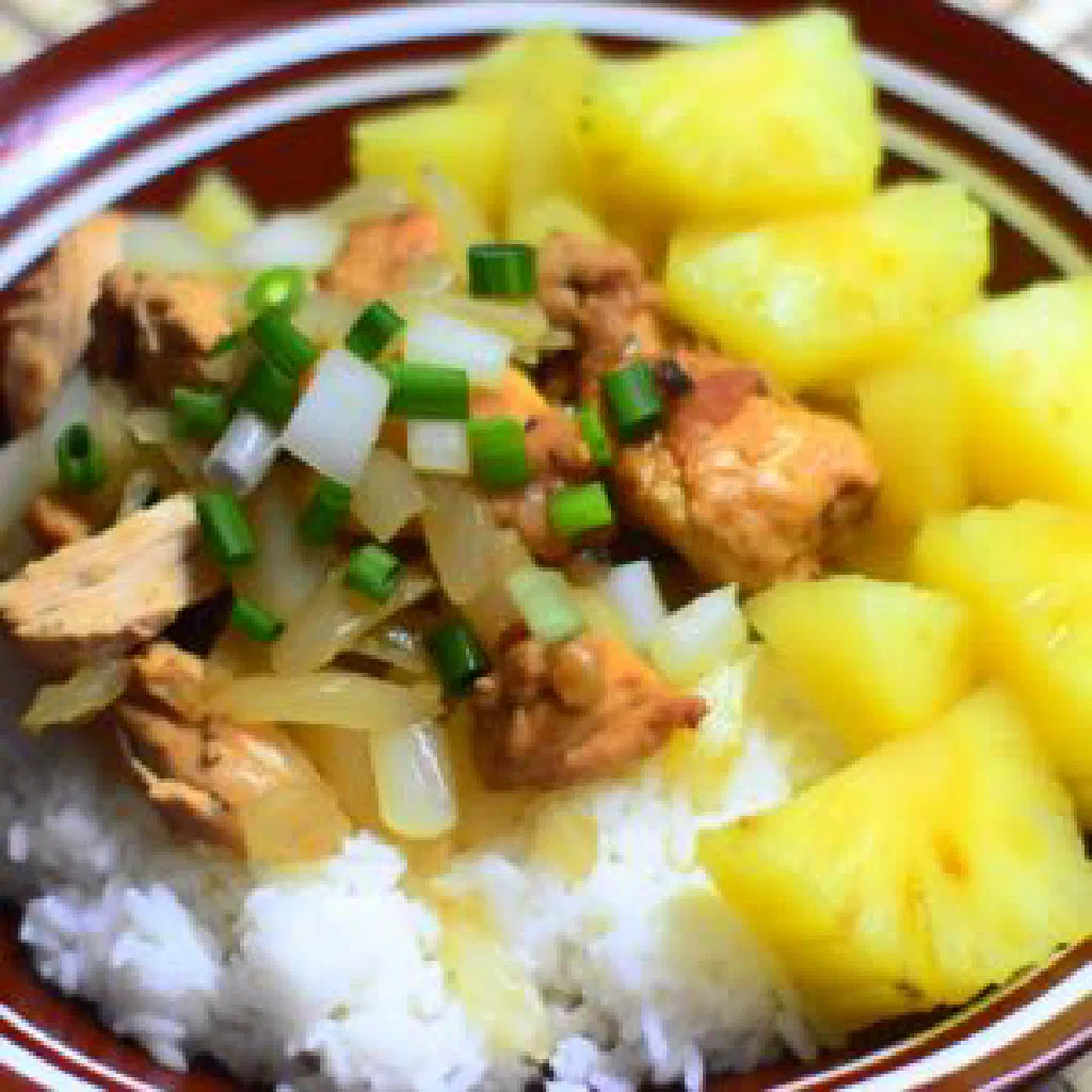Bowl of diced pineapple tossed with roasted peanuts and mint
