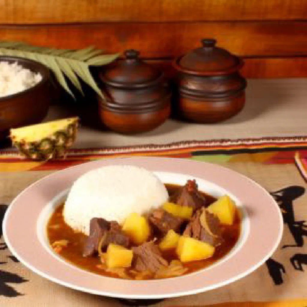 Malagasy beef and greens stew served in a traditional bowl