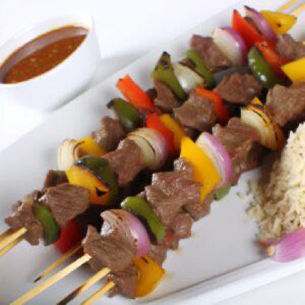 Grilled marinated beef served with rice and fresh vegetable salsa