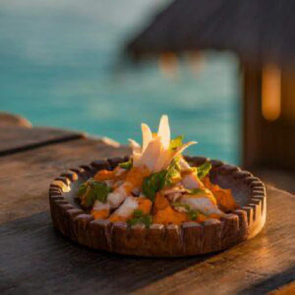 Golden fried Maldivian kavaabu fish balls on a plate with fresh herbs