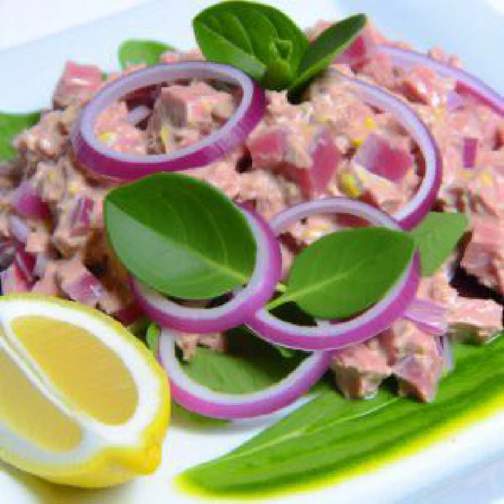 Lonu huni with flaked tuna, grated coconut and lime on a plate