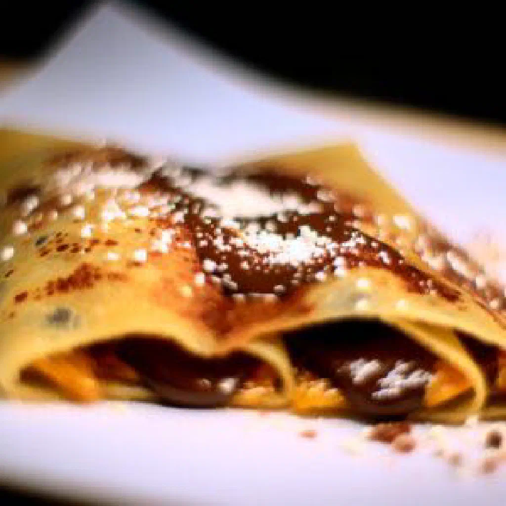 Rolled crispy marquesita waffle filled with cheese and chocolate