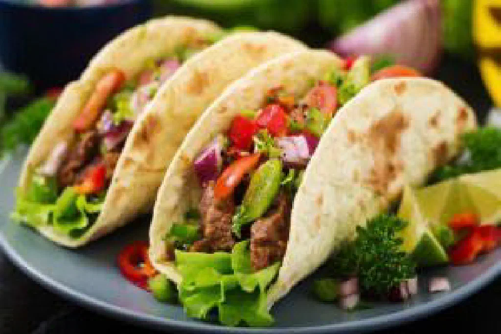 Mexican tacos with seasoned minced beef, salsa and chopped onions