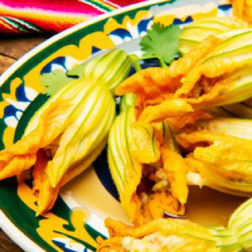 Golden fried zucchini blossoms stuffed with cheese on a plate