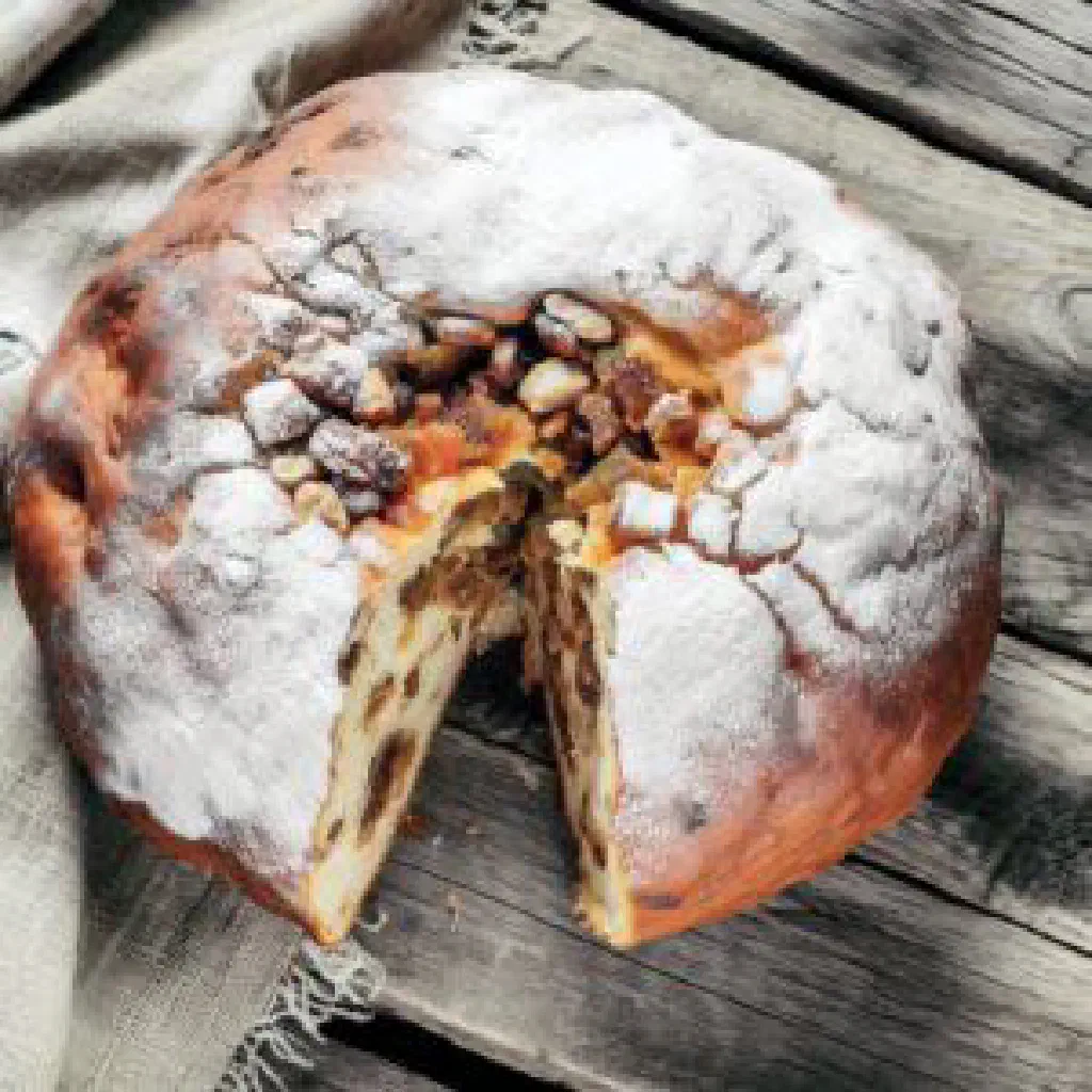 Slice of Baba Neagră with dark chocolate layers and a soft cream topping