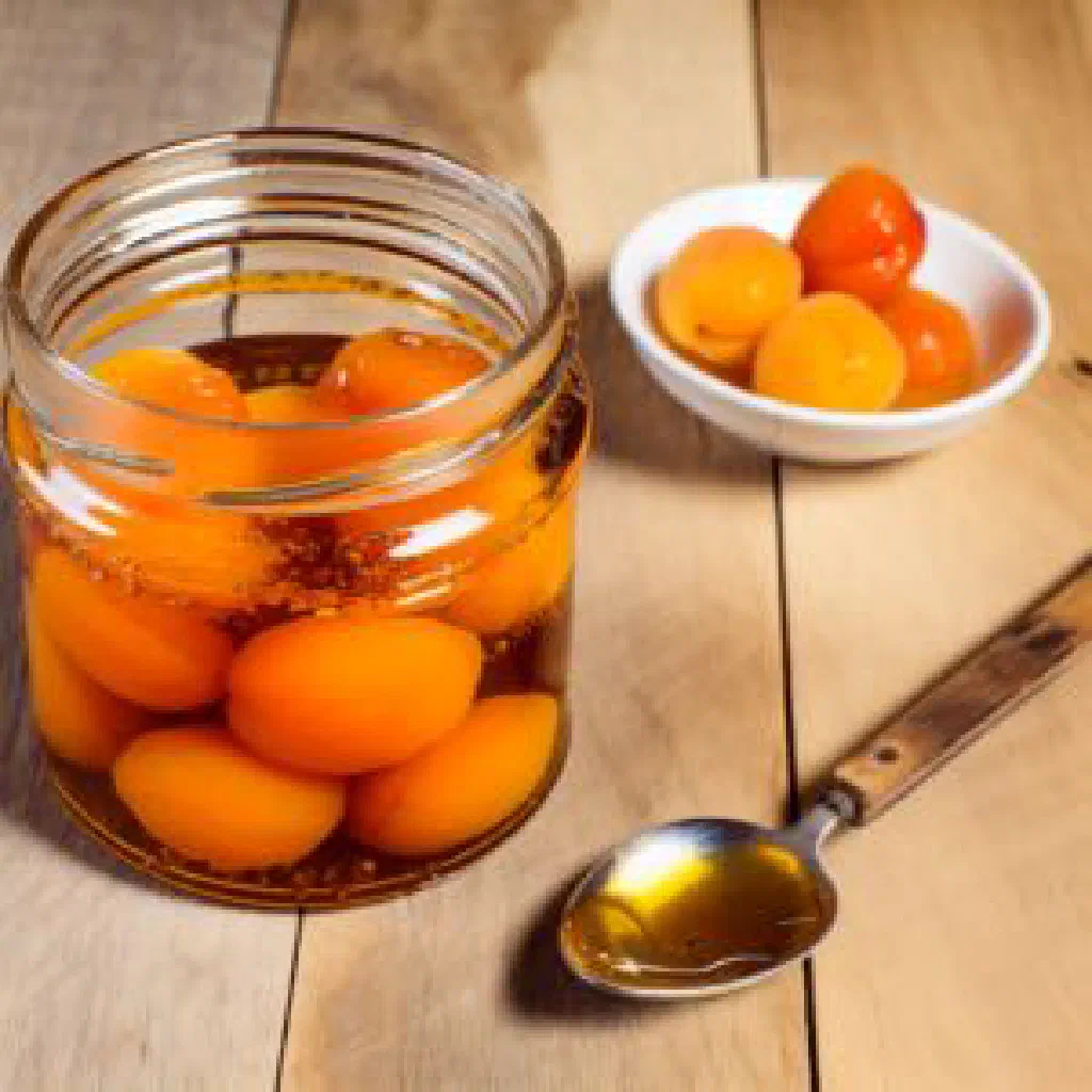 Boerenmeisjes brandied dried apricots served in a small glass with a dusting of cinnamon