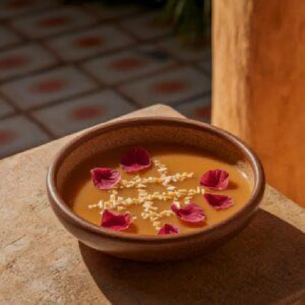 Creamy leche burra dessert in a small glass topped with desiccated coconut